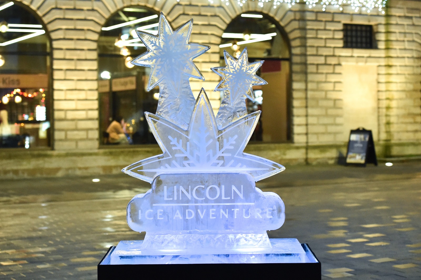 An ice sculpture with Lincoln Ice Adventure text engraved in it.