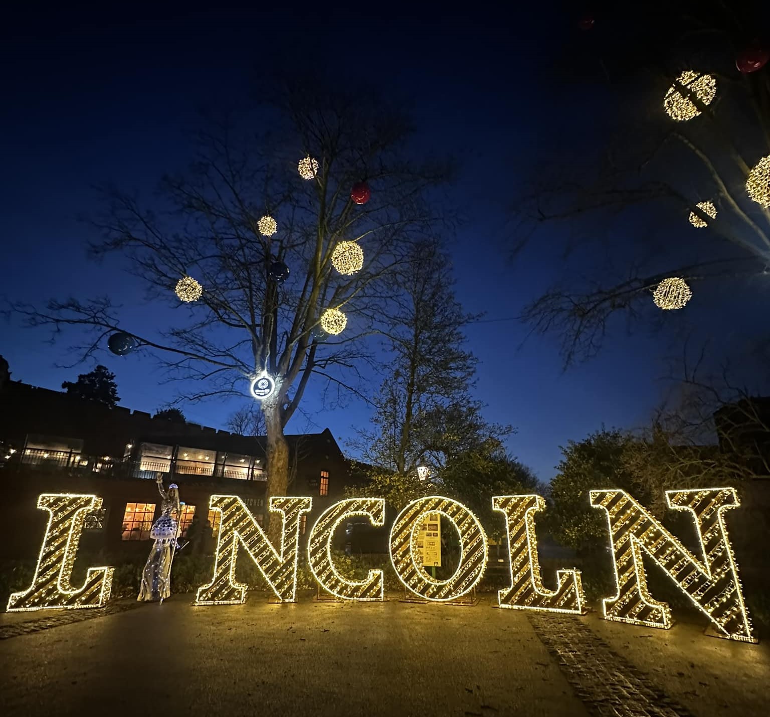 LINCOLN letter blocks lit up against a dark winter sky.