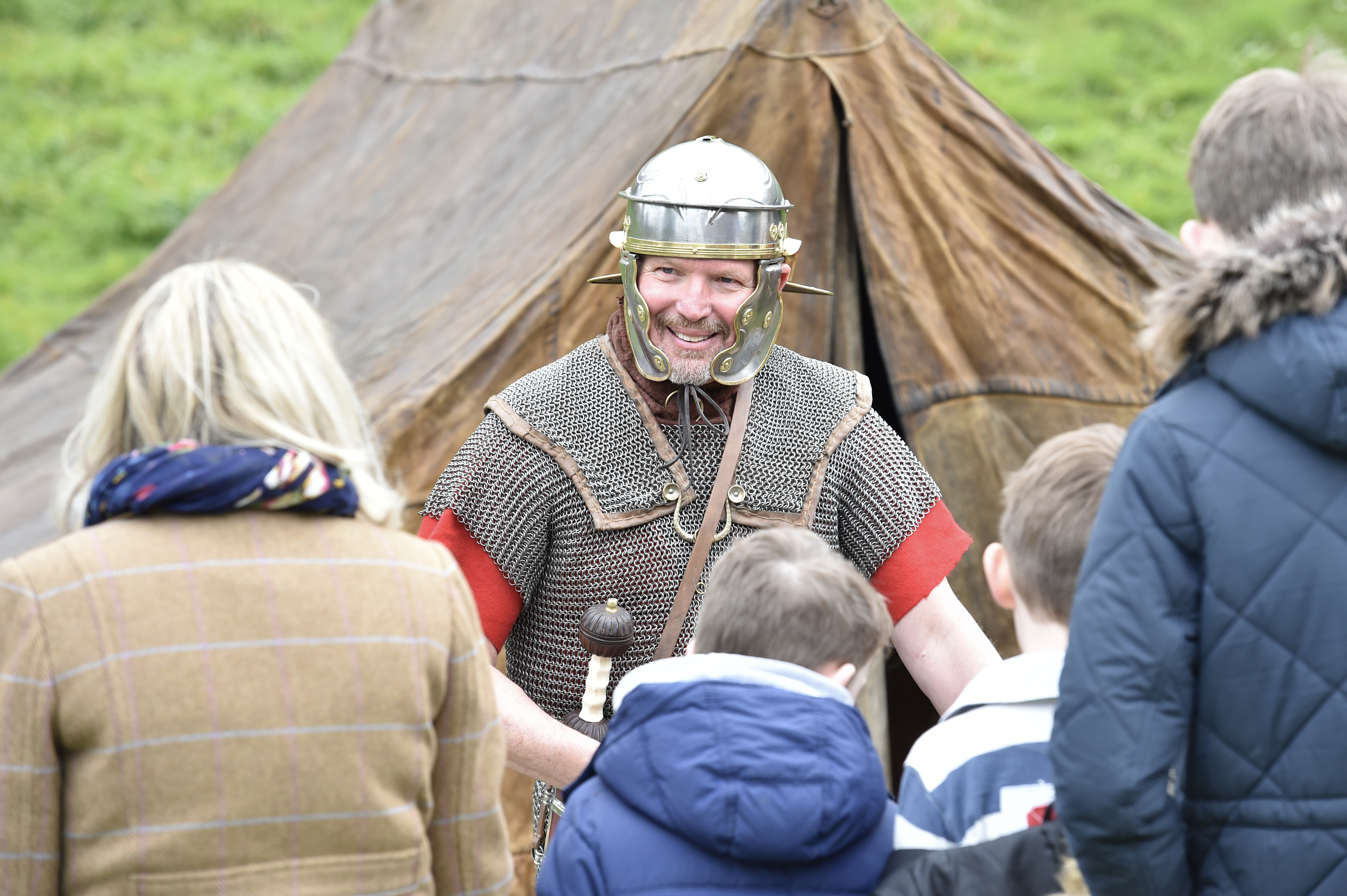 A man dressed as a viking smiling to a crowd of people.