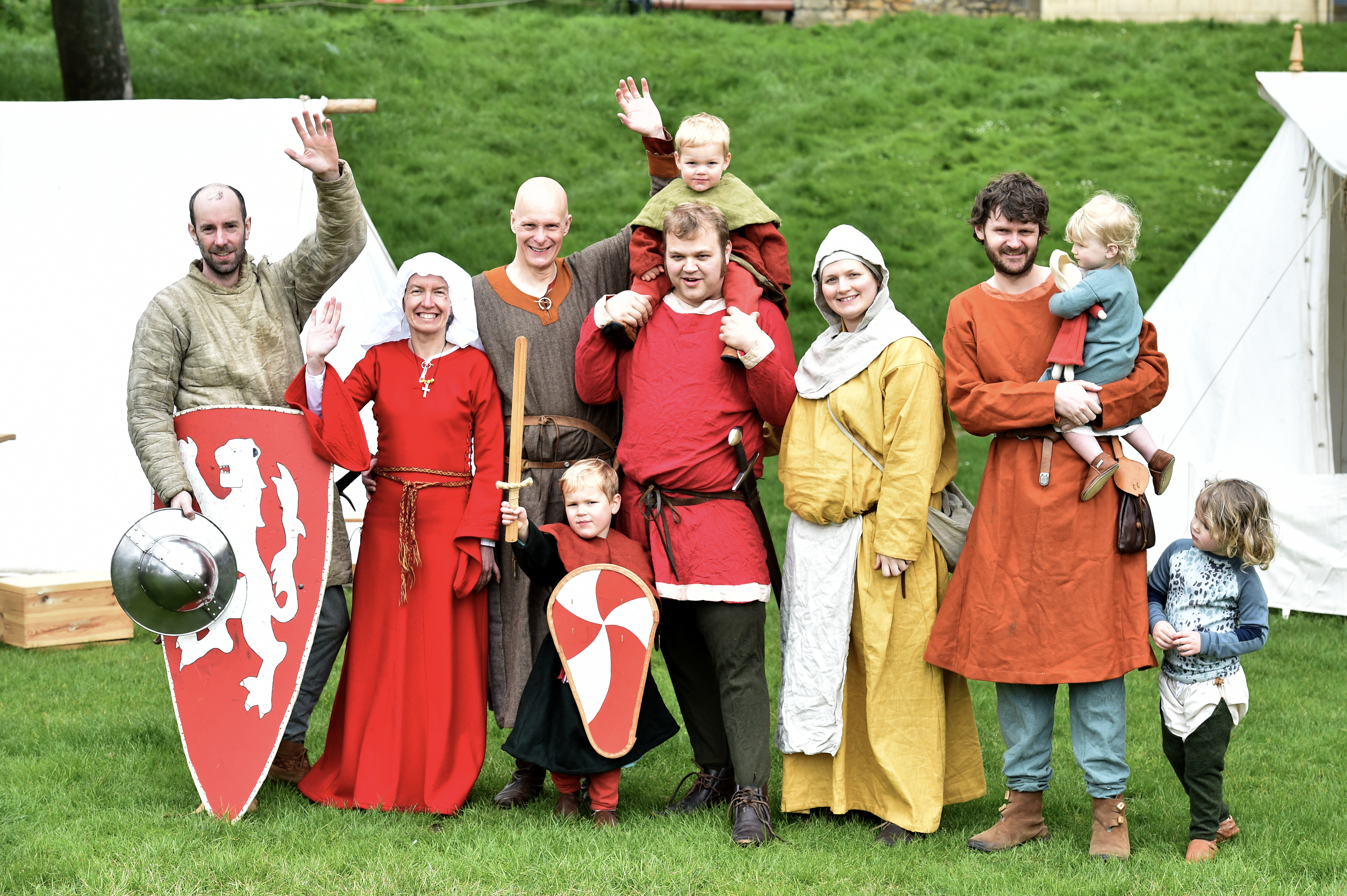 A group photo of men, women and children dressed in historic costume.