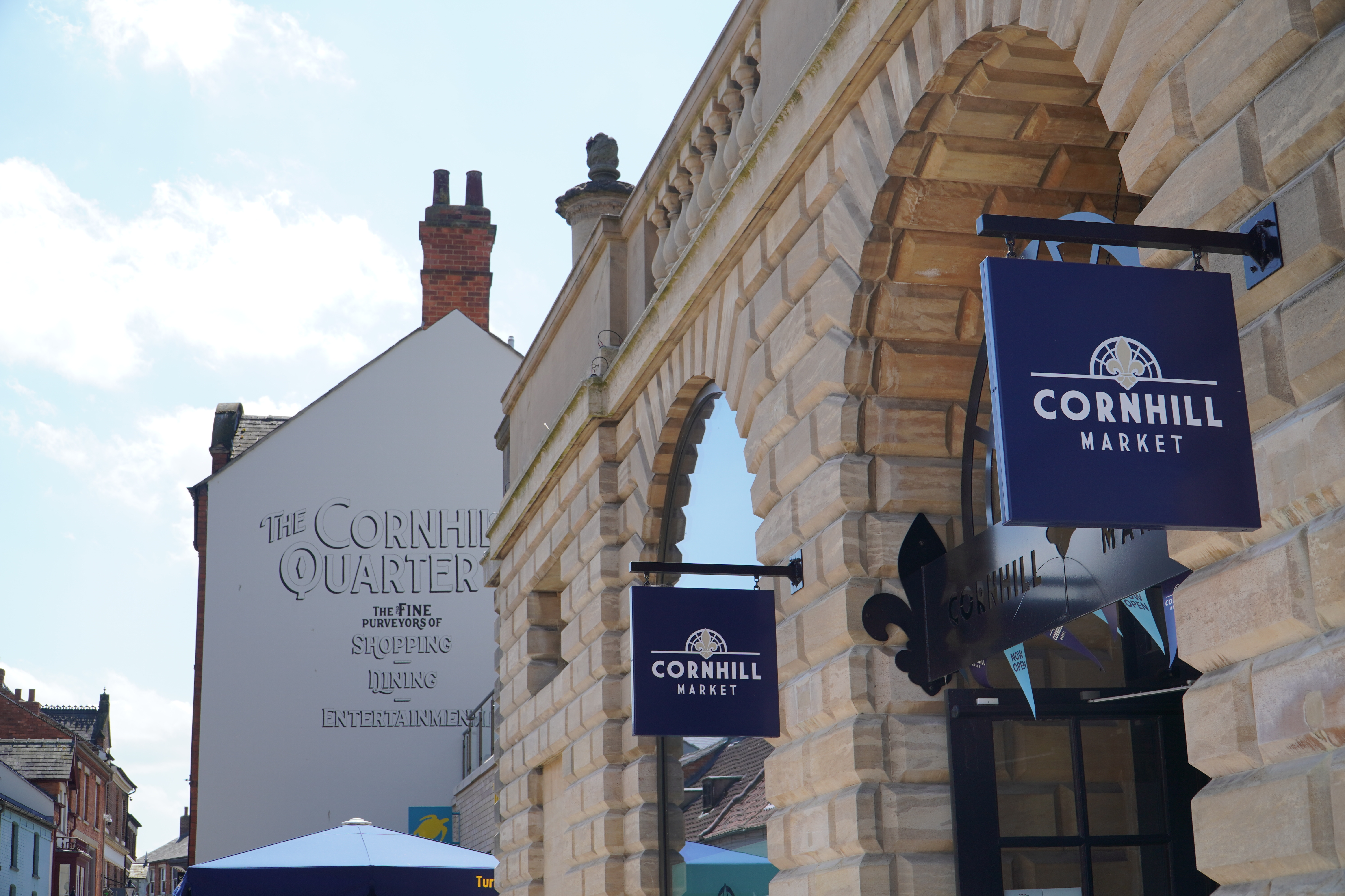 A photo of the Cornhill Market's exterior, focusing on the market's signage.