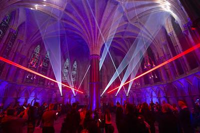 A previous event from Frequency Festival inside Lincoln Cathedral Chapter House, a light show with purple and red lasers illuminating the room in an atmospheric light display.